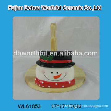 Ceramic tissue holder in snowman shape with wooden part